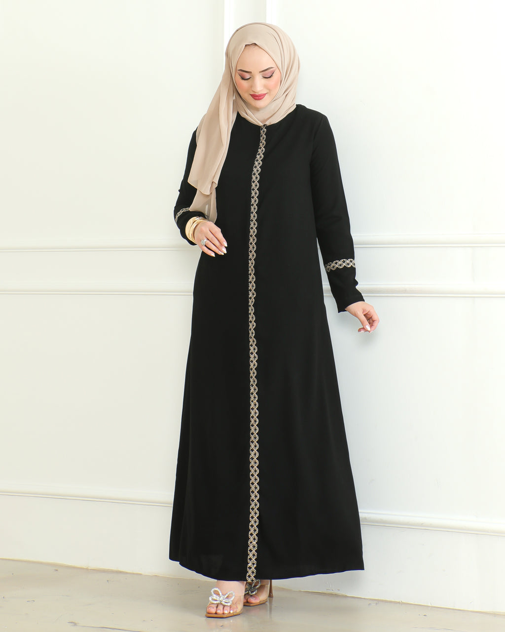 Black embroidered abaya with gold lace centre-front trim and cuff detail, full-length front view