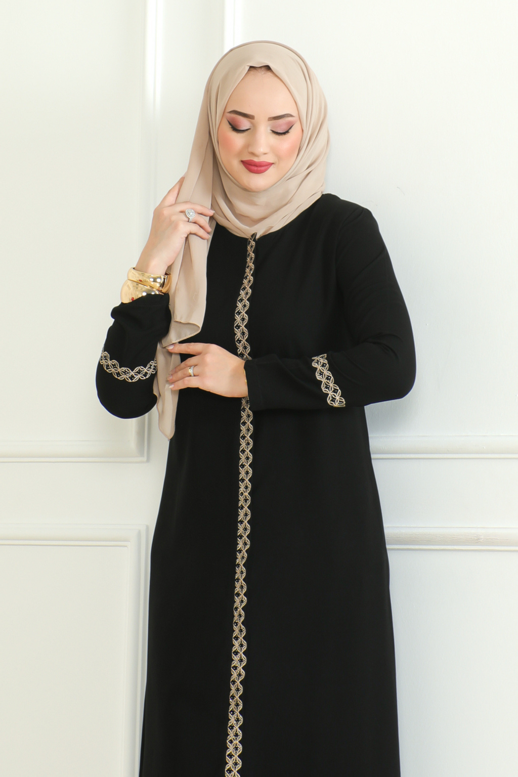 Black lace-trim abaya styled with a coordinating hijab for everyday modest wear
