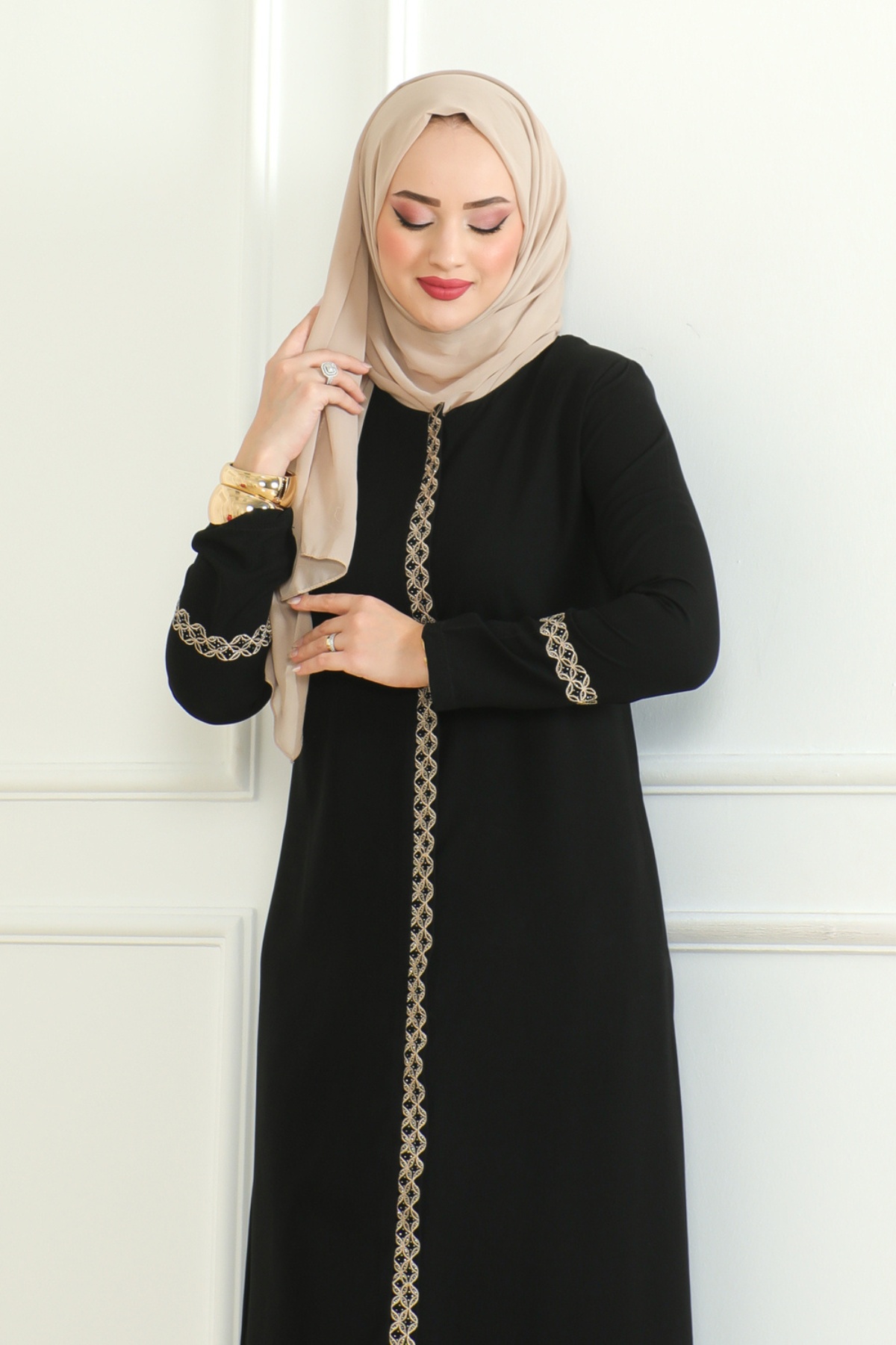 Black lace-trim abaya styled with a coordinating hijab for everyday modest wear