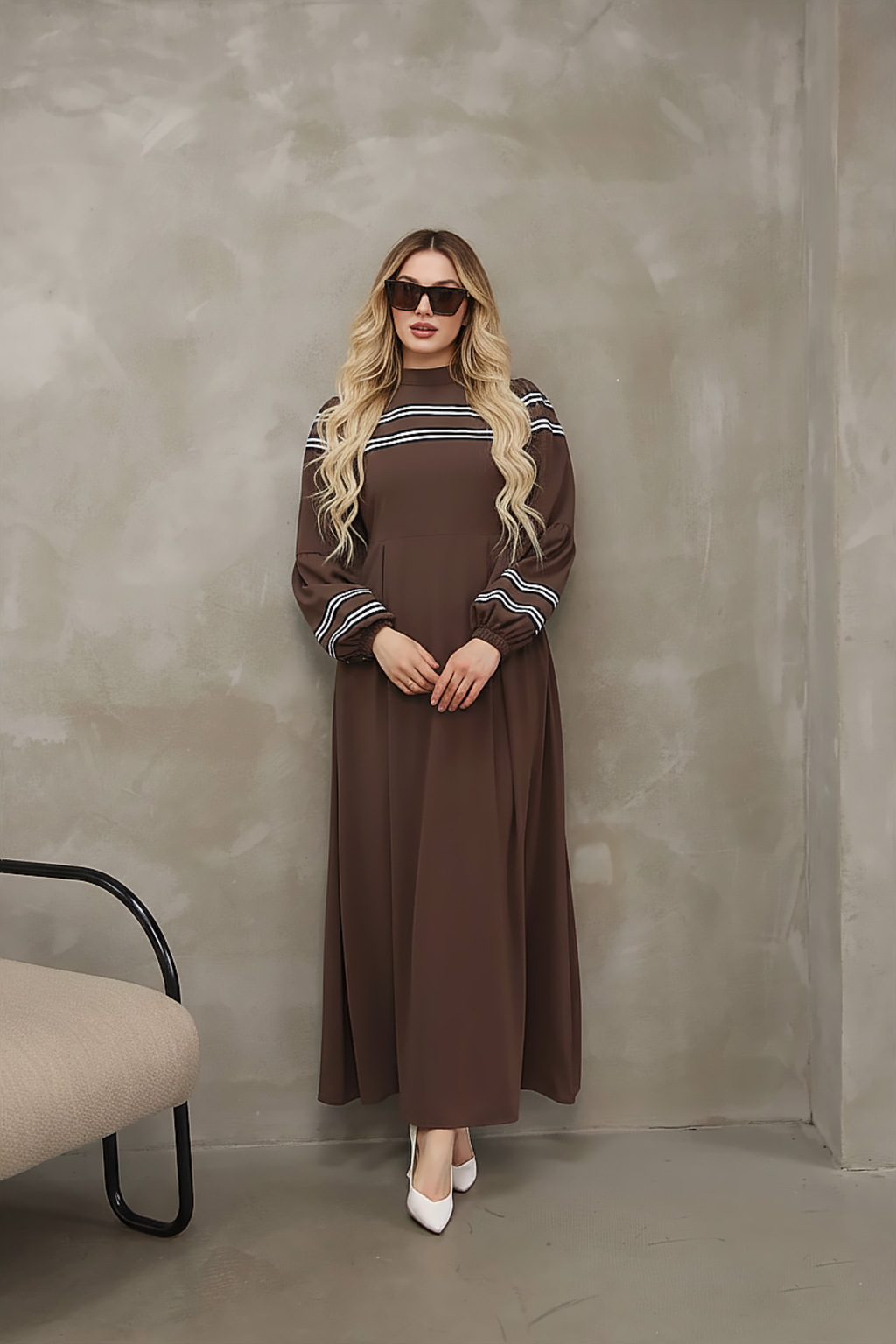 Close-up of contrast stripe trim at the neckline of a brown modest maxi dress