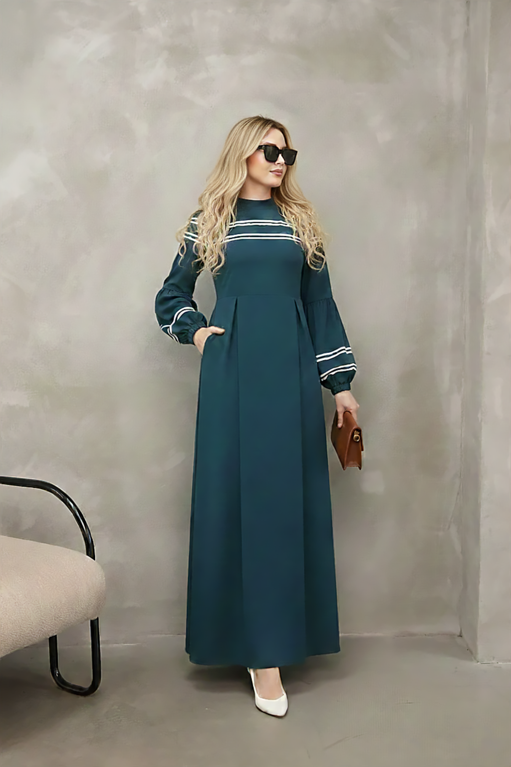 Close-up of contrast stripe trim at the neckline of a navy modest maxi dress