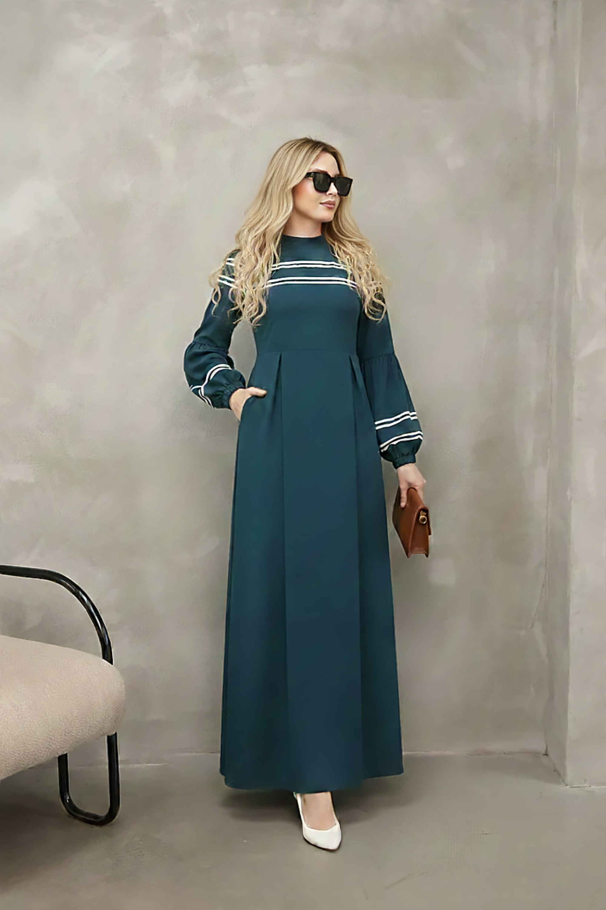 Close-up of contrast stripe trim at the neckline of a navy modest maxi dress