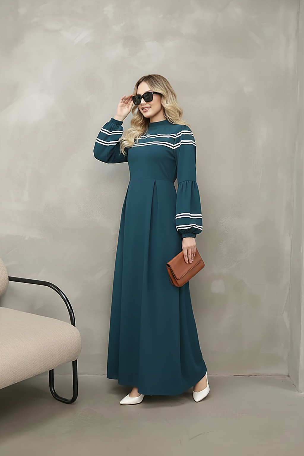 Detail of balloon sleeve with contrast stripe cuff on a navy maxi dress