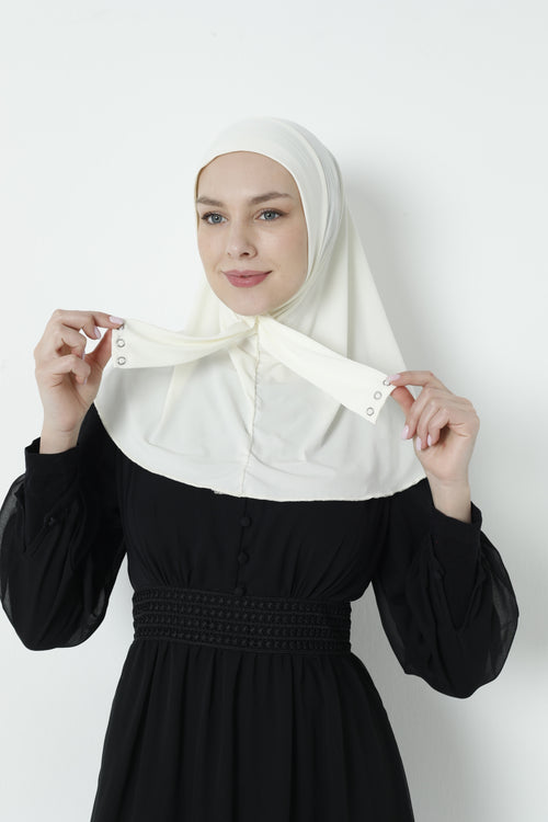 Woman in white instant hijab holding up both snap-button tie ends to show the closure detail, front view