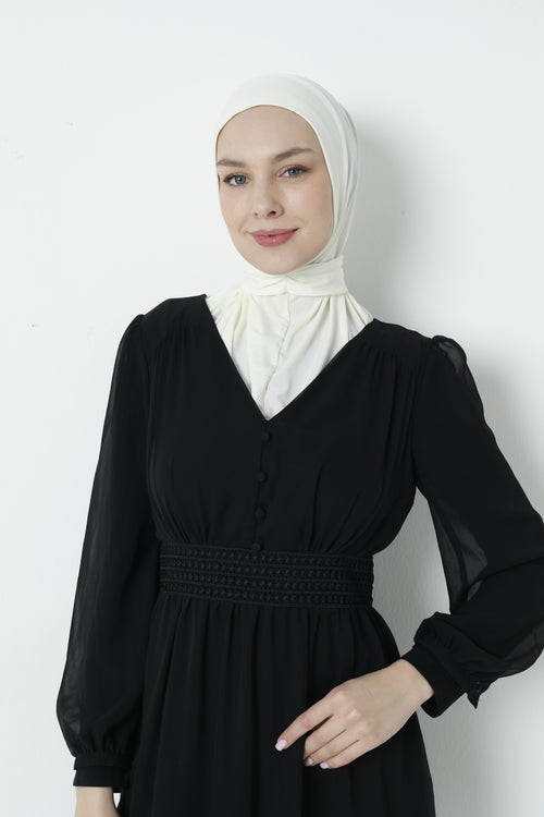 Close-up front view of woman wearing white ready-to-wear hijab with smooth sandy fabric draped around shoulders