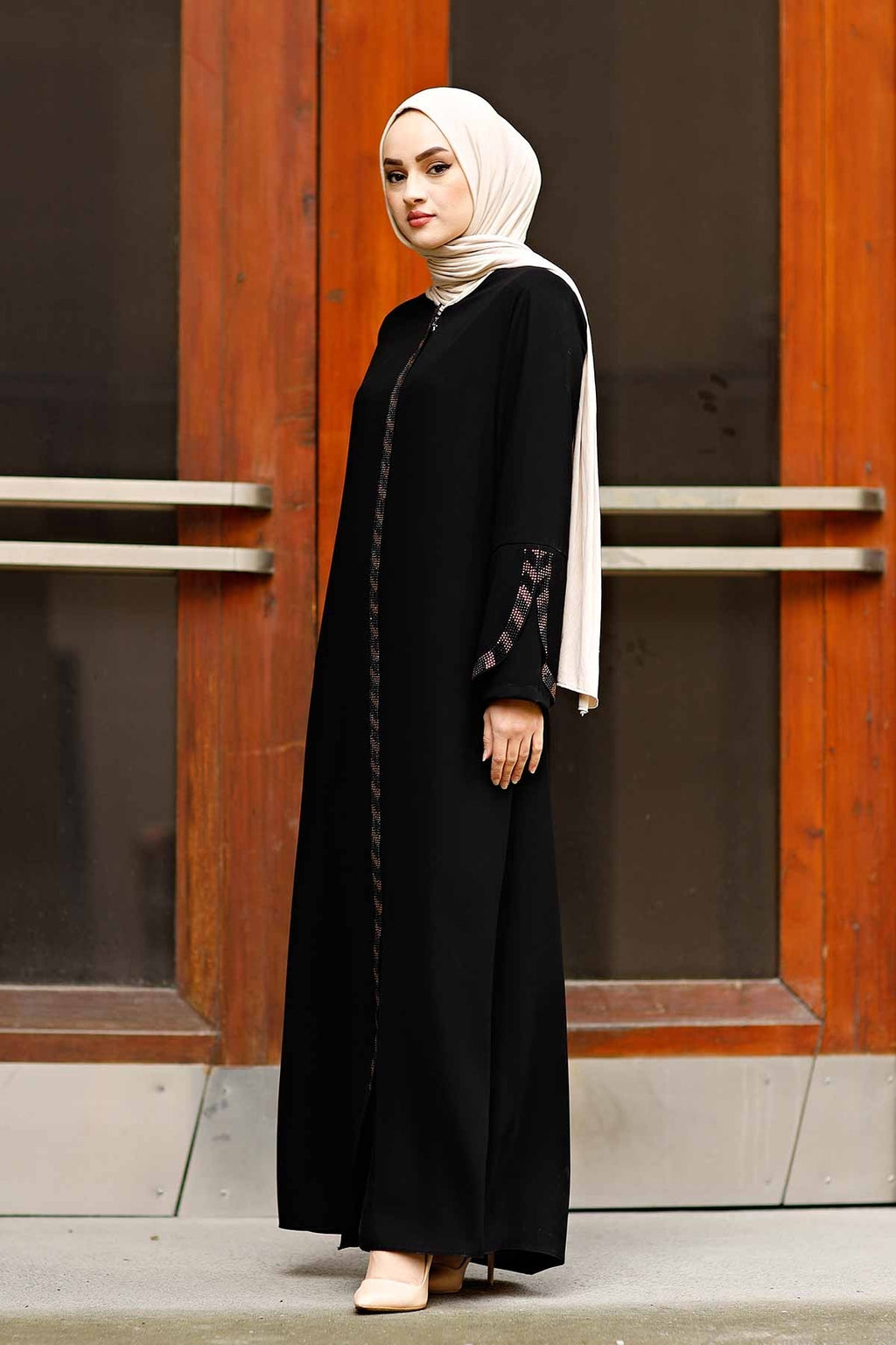 Close detail of rhinestone trim along the sleeve cuff of a black Turkish abaya