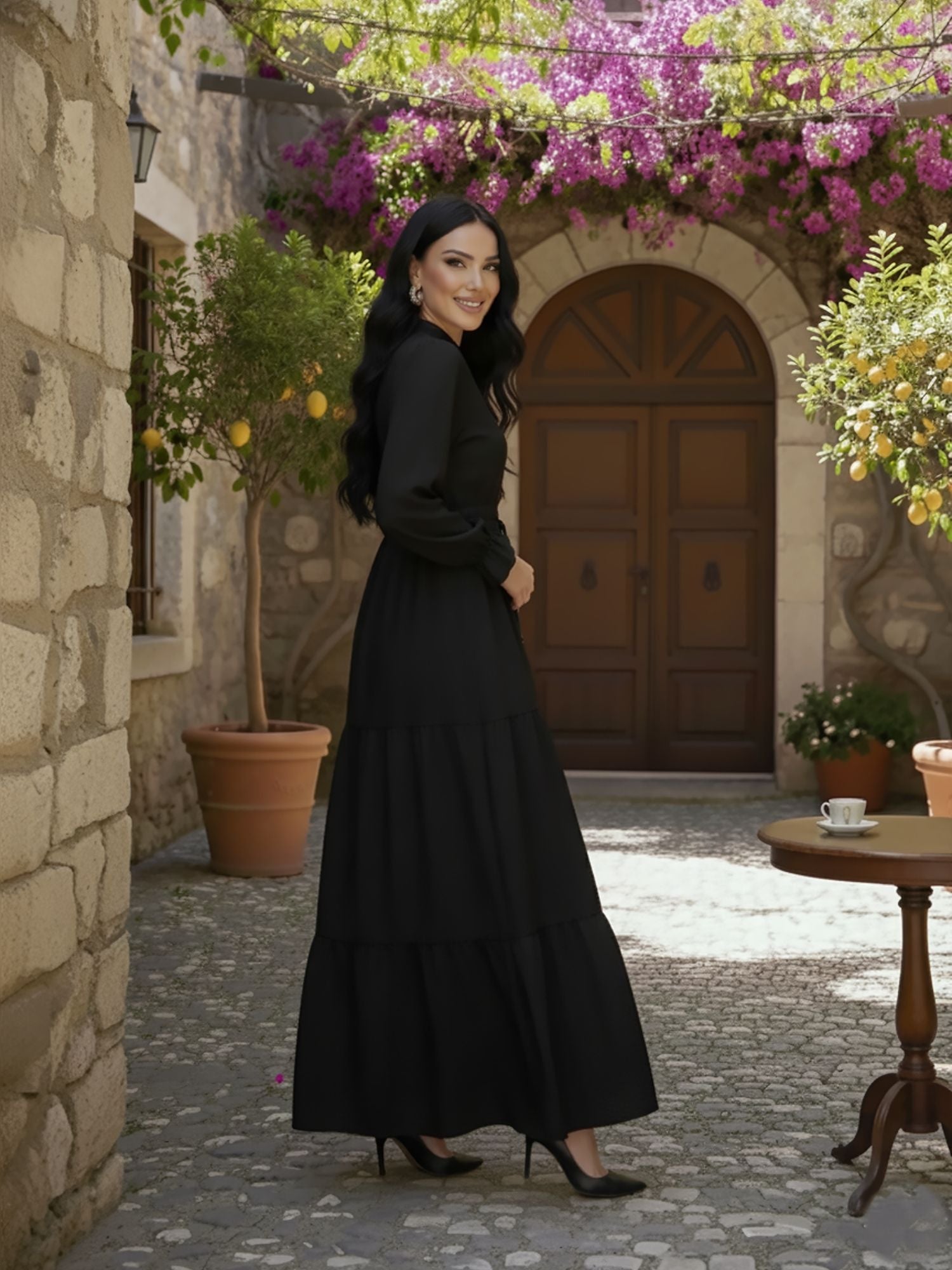 Side view of black tiered modest maxi dress showing flowing tiered skirt
