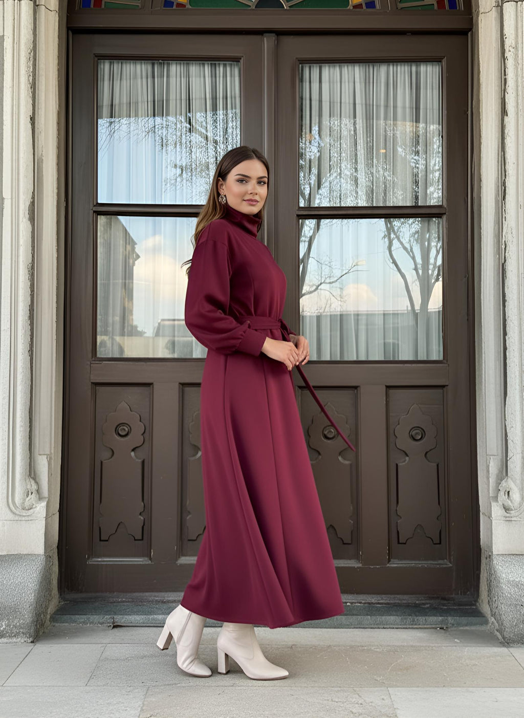 Red winter maxi dress showing high turtleneck neckline and self-tie waist belt