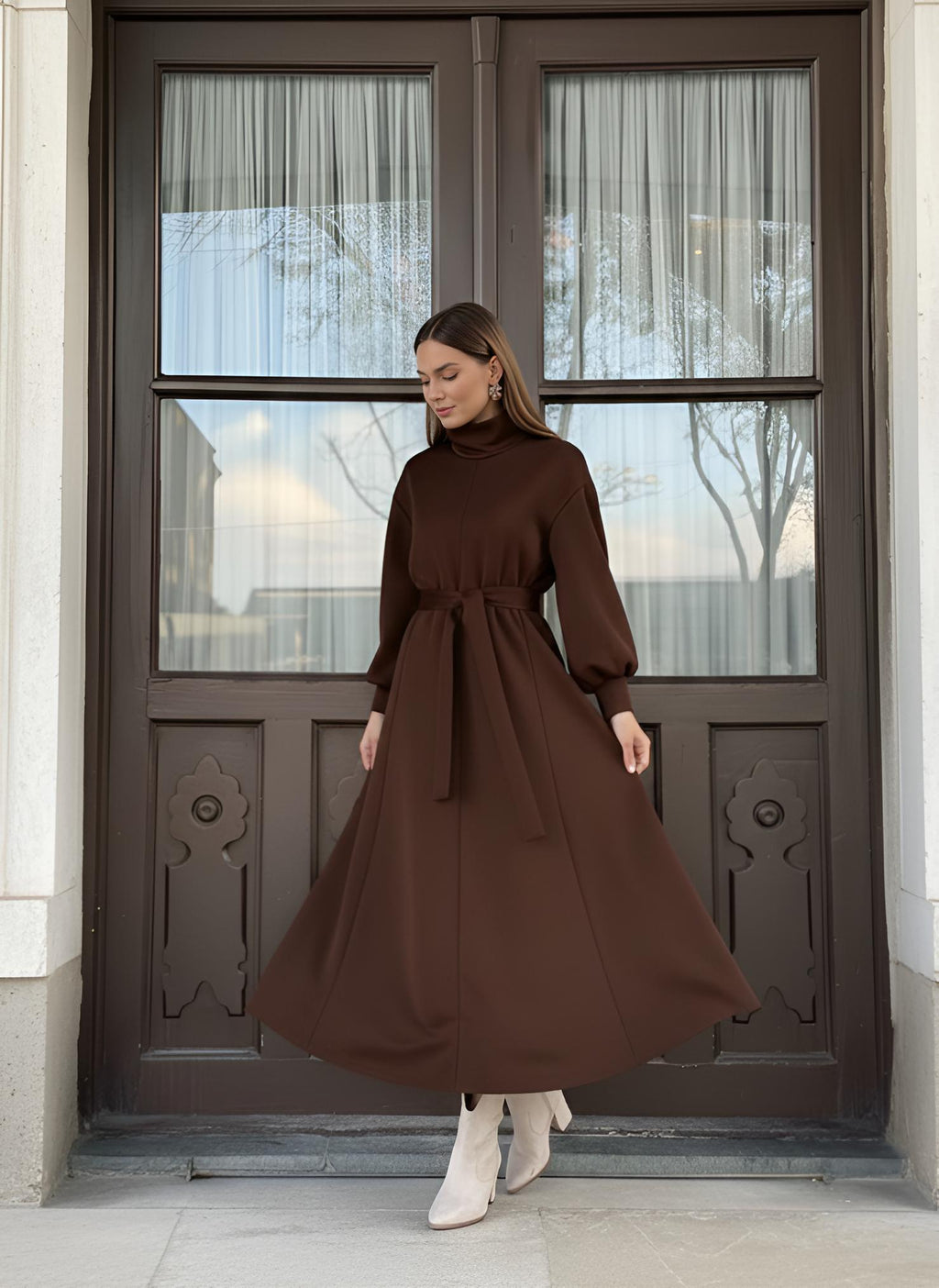 Brown winter maxi dress showing high turtleneck neckline and self-tie waist belt
