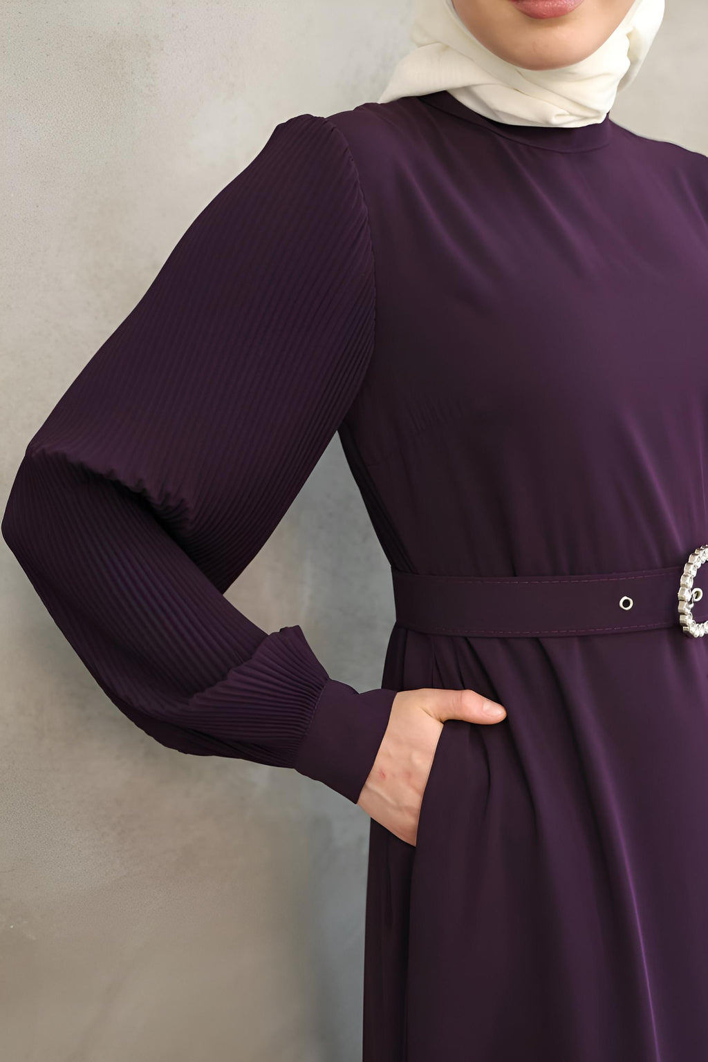 Close-up of pearl-embellished buckle belt on a purple two-tone maxi dress