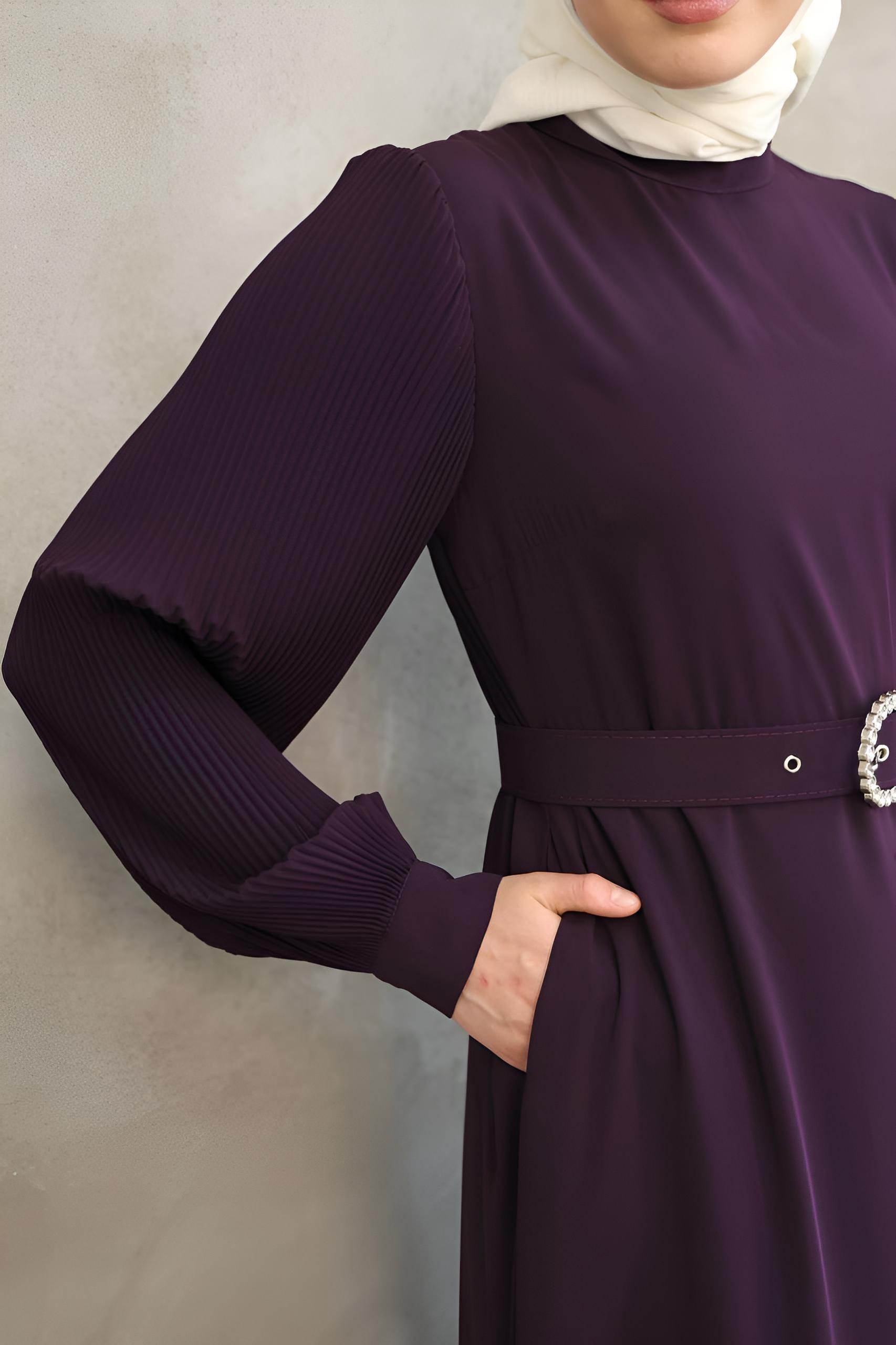 Close-up of pearl-embellished buckle belt on a purple two-tone maxi dress