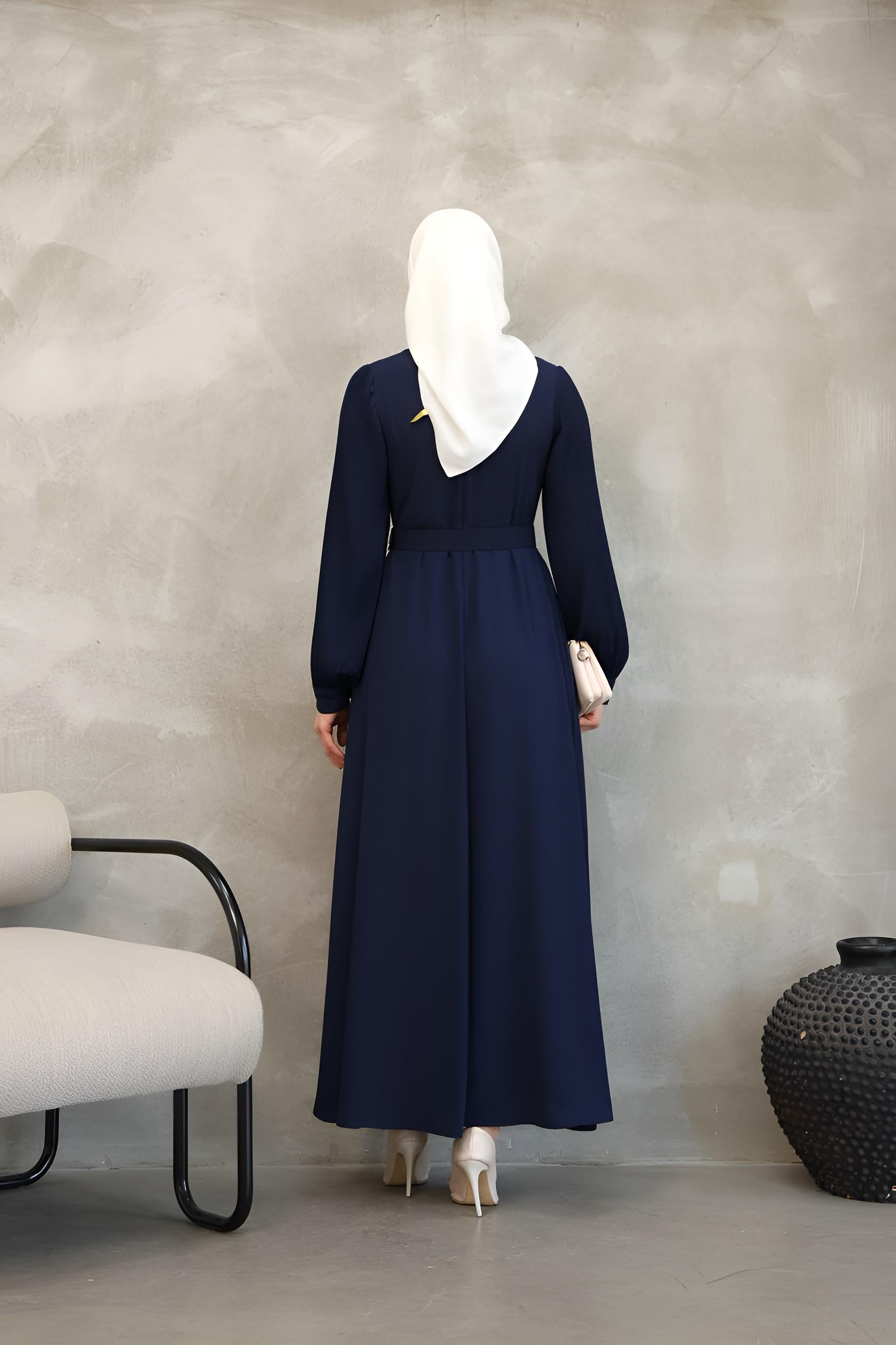 Detail of pleated balloon sleeve on a navy asymmetrical modest maxi dress