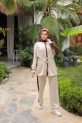 Istanbul Styles Beige two-piece modest tracksuit set — model in garden setting showing contrast brown stripe and drawstring t