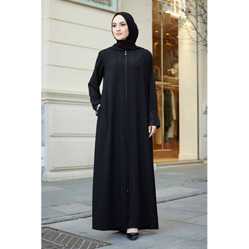 Full-length black Turkish abaya with front zip and lace cuffs, worn outdoors by a hijabi woman