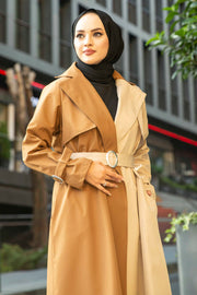 a woman in a yellow coat is standing outside
