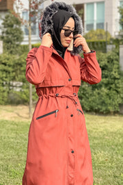 a woman in a red dress talking on a cell phone